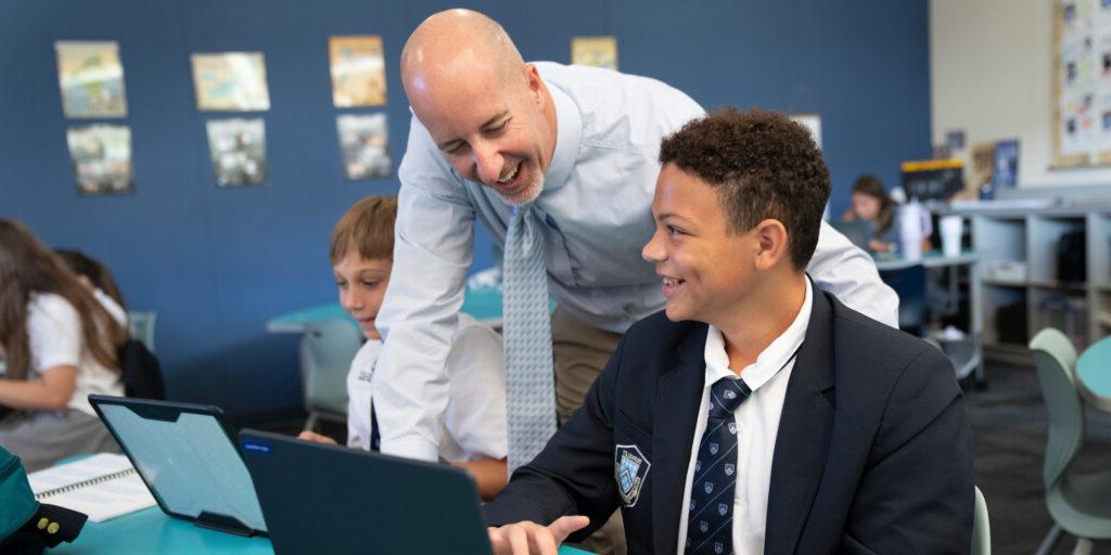 Teacher in classroom with student